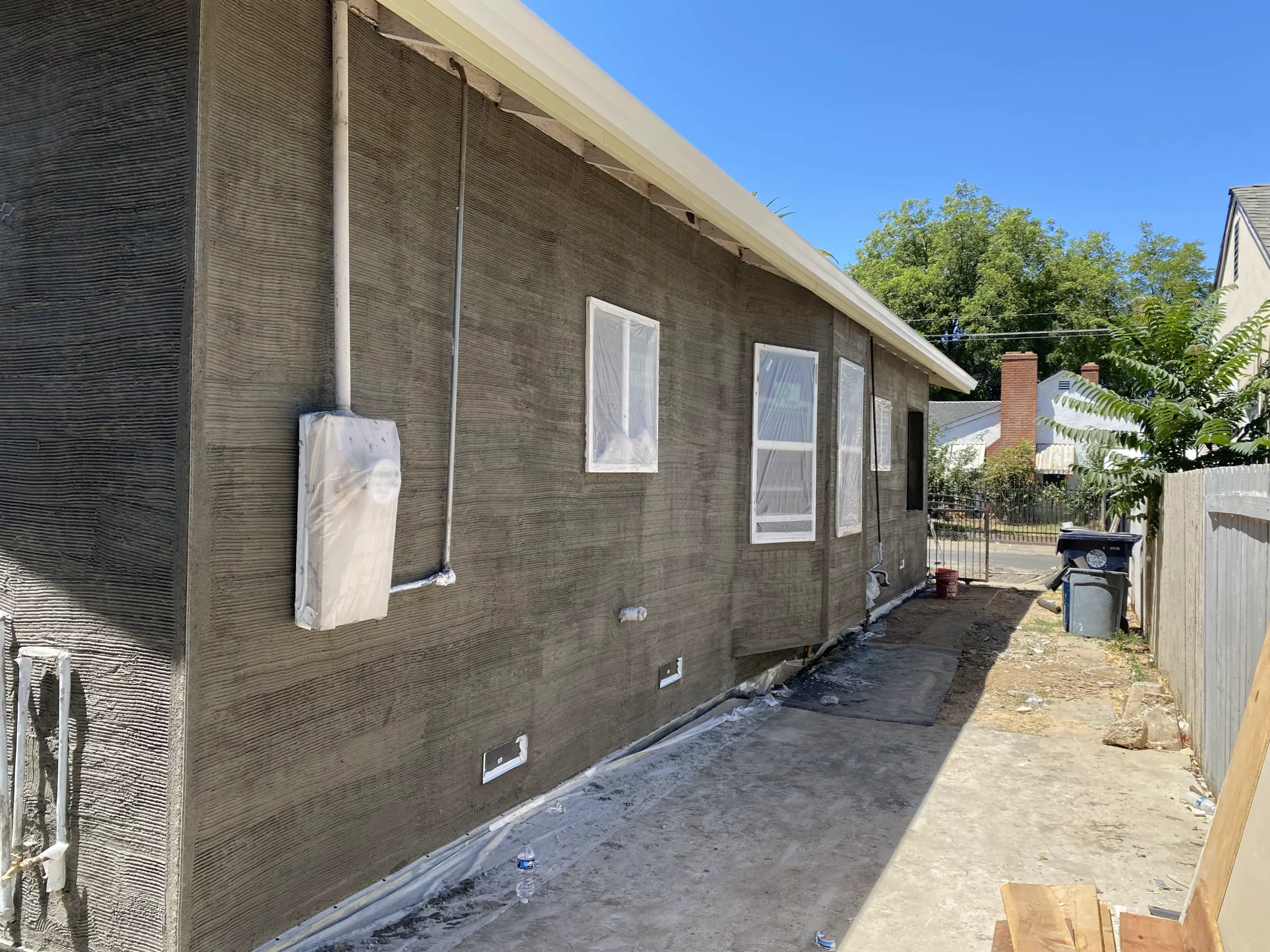 General construction contractor, a house is being built in a backyard.