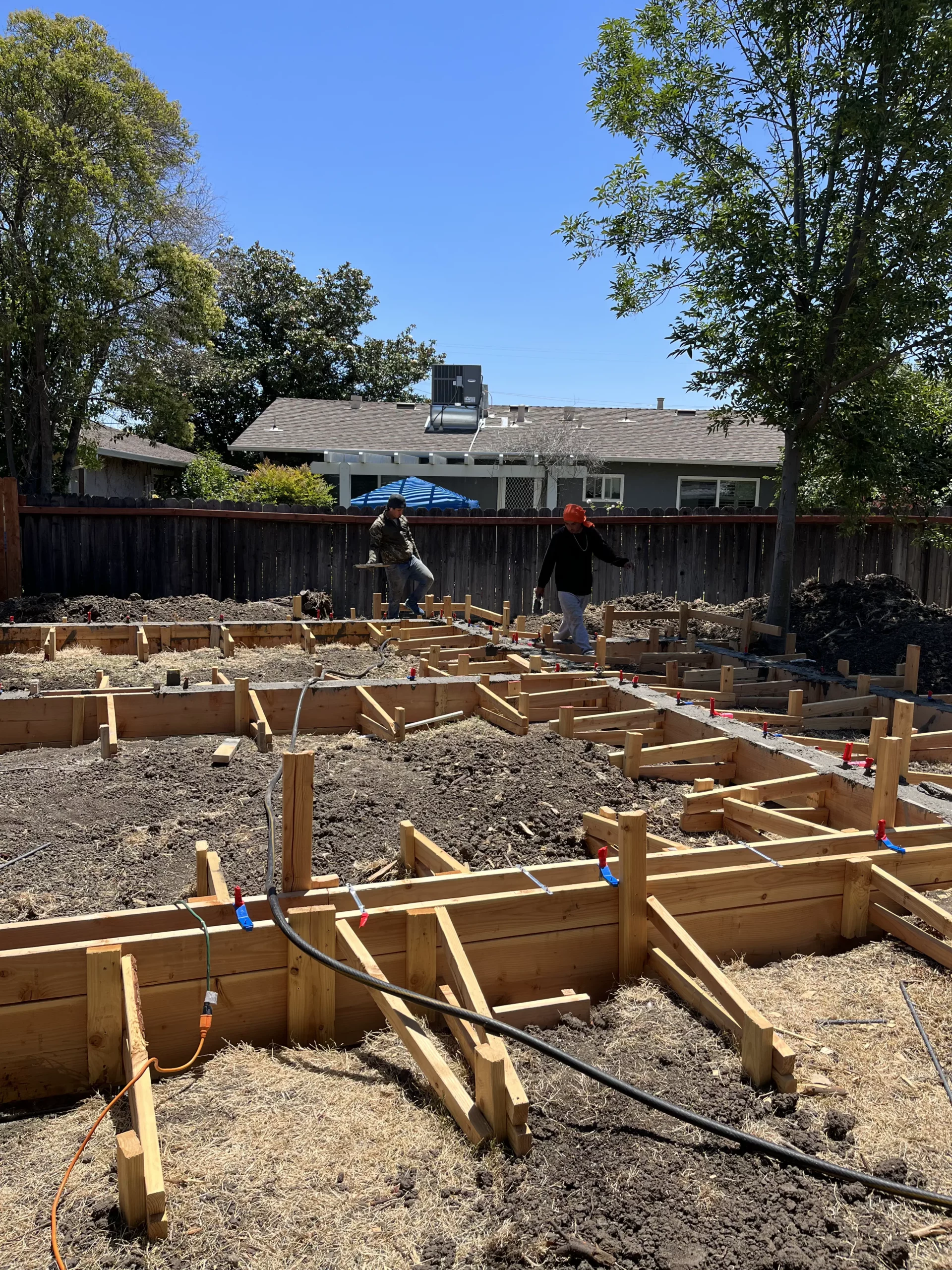 A man is working on the foundation of a house.