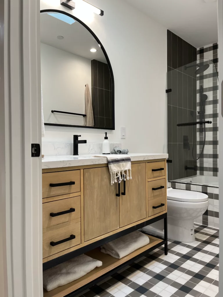 A bathroom with a black and white checkered floor.
