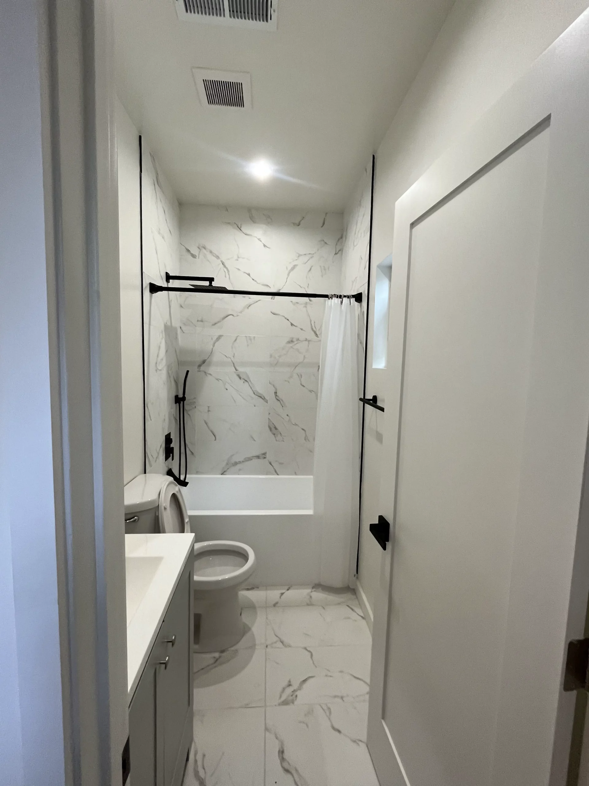 A white bathroom with a toilet and sink.