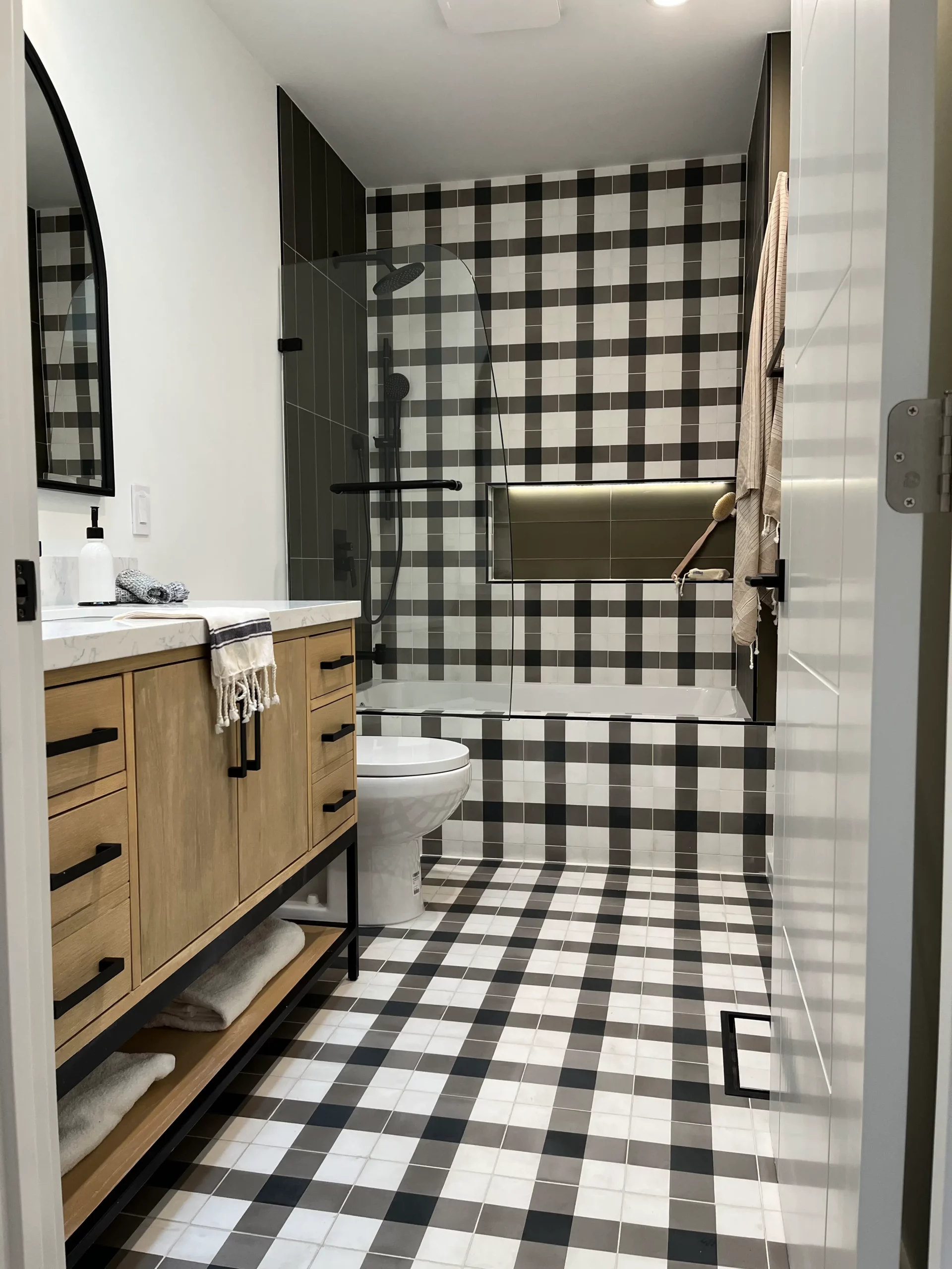 A bathroom with a black and white checkered floor.