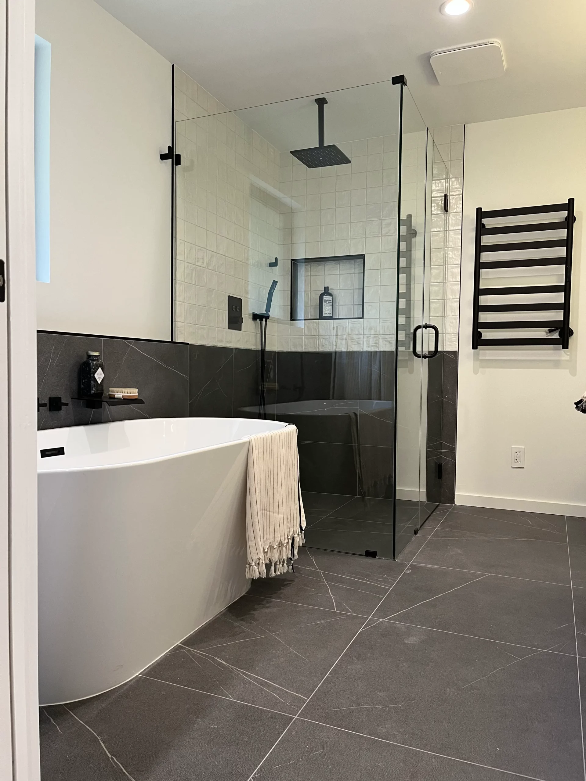 A modern bathroom with a glass shower and tub.