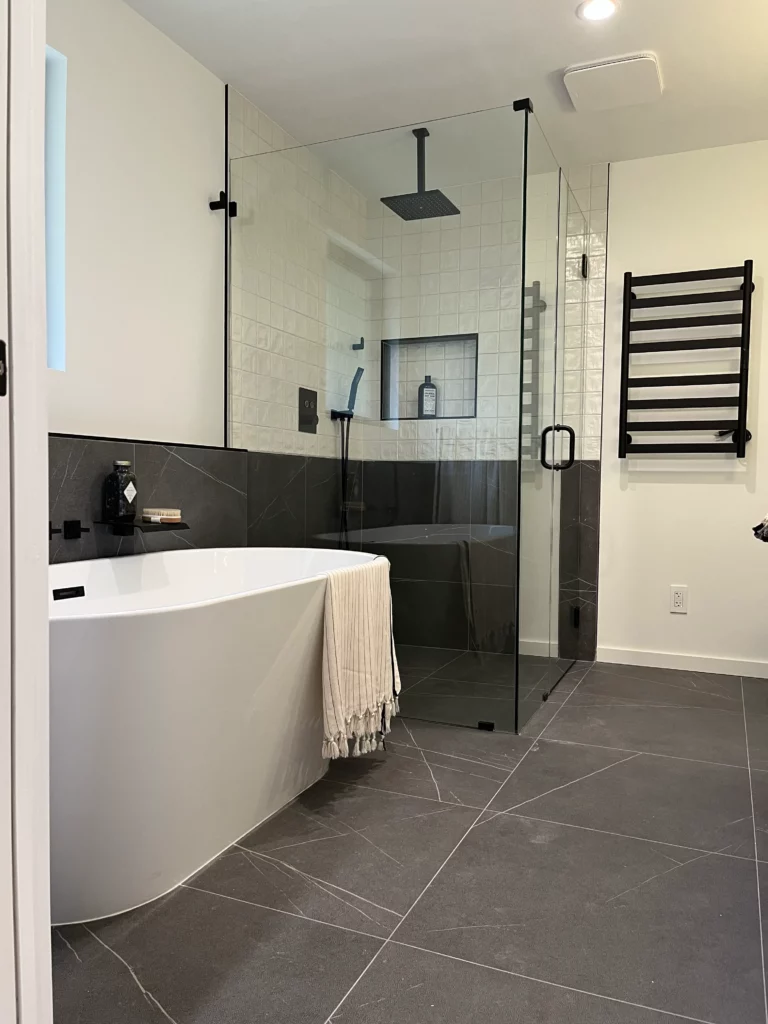 A modern bathroom with a glass shower and tub.