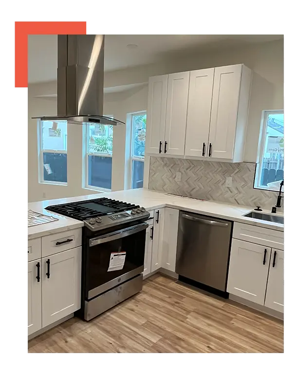 A kitchen with white cabinets and stainless steel appliances.