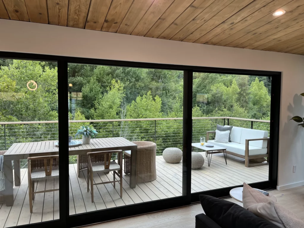 A living room with sliding glass doors and a deck.