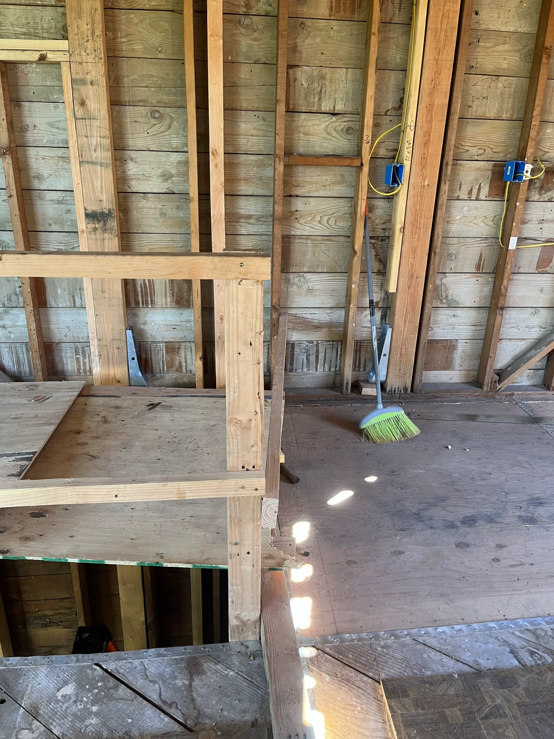 A room that is being remodeled with a wooden floor.