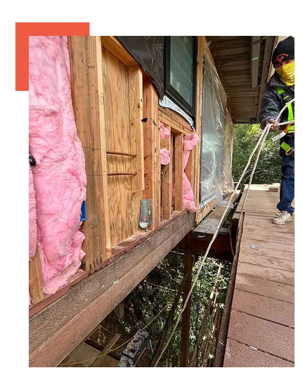 A man is working on a wooden deck.