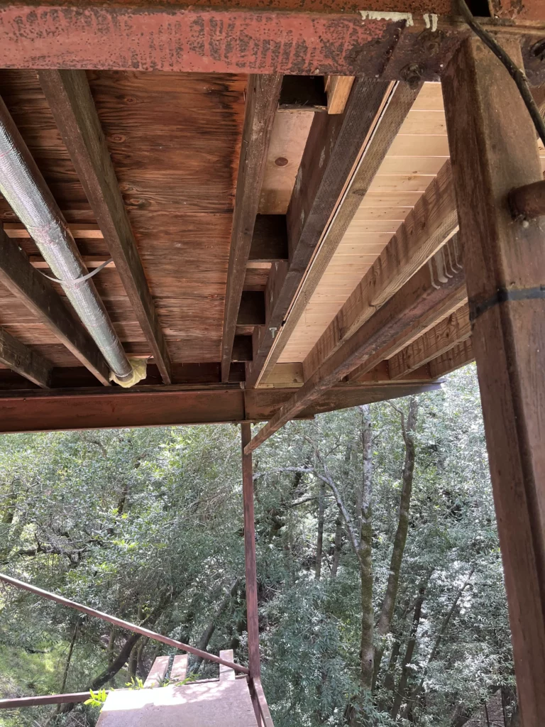 A wooden deck with a wooden railing.
