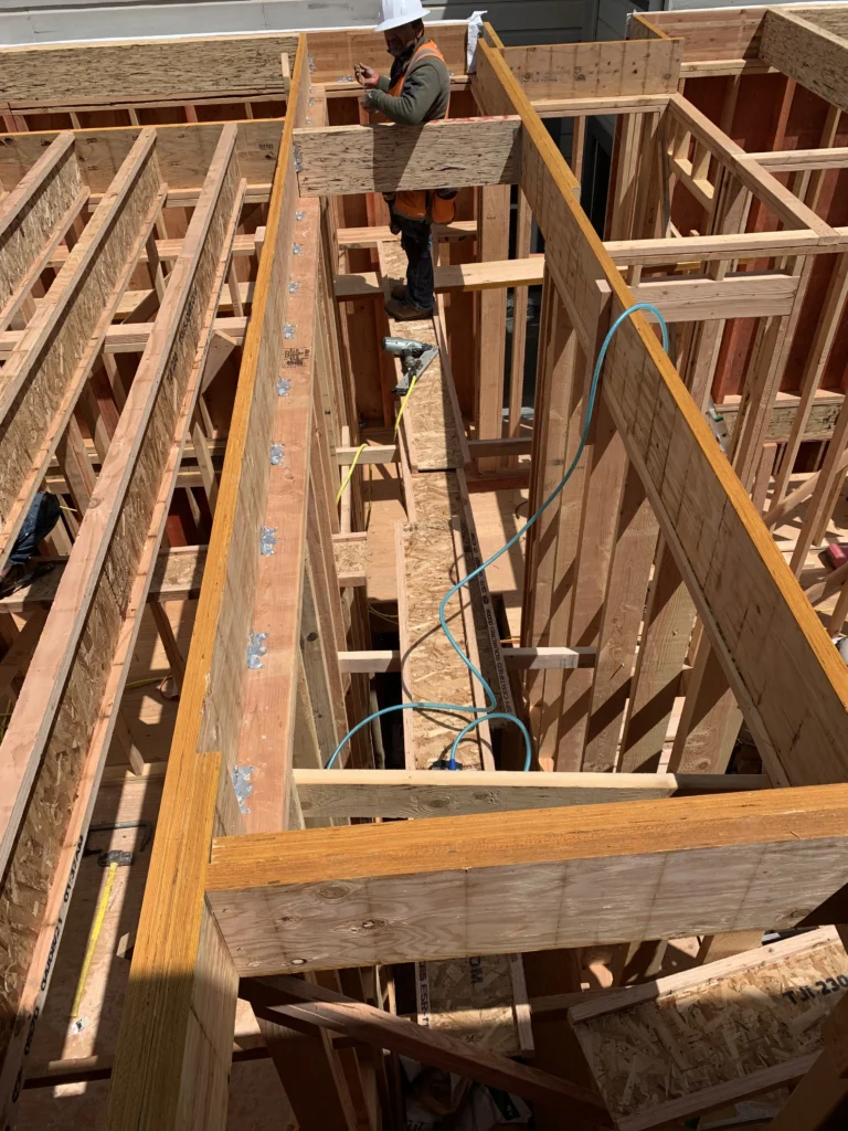 A man is working on framing for a house.